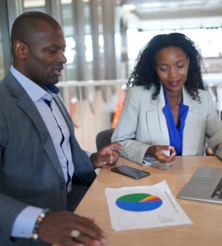 Value Added Services young man consulting his business partner at meeting in office