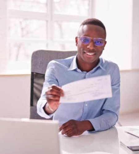 Value Added Services holding paycheck or payroll check or insurance cheque in hand