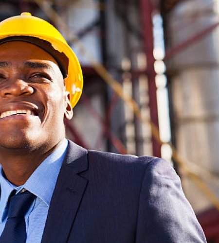 happy african industrial manager at oil refinery plant