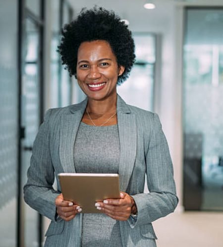 Value Added Services shot of beautiful smiling businesswoman holding digital tablet in the office.